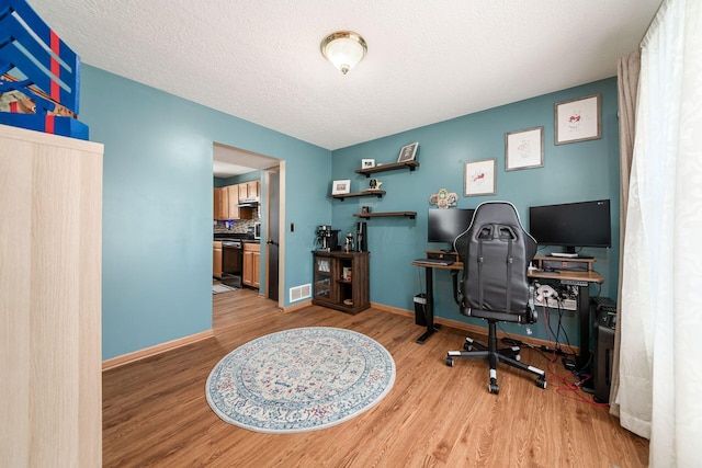 office space featuring wood-type flooring and a textured ceiling