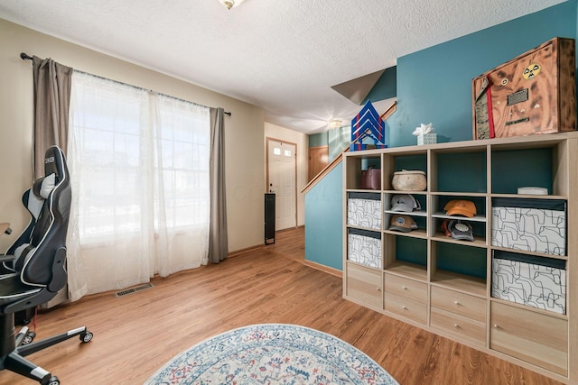 office space featuring hardwood / wood-style flooring and a textured ceiling