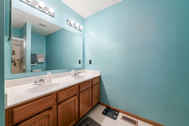 bathroom with tile patterned flooring, vanity, an enclosed shower, and toilet