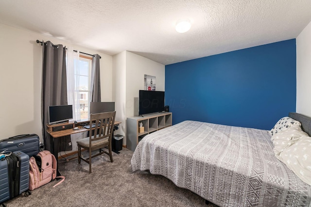 bedroom with carpet floors and a textured ceiling