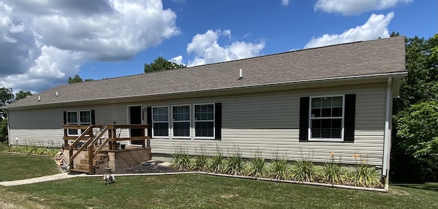 back of property featuring a lawn