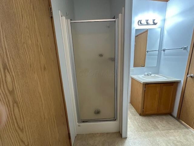 bathroom featuring walk in shower and vanity