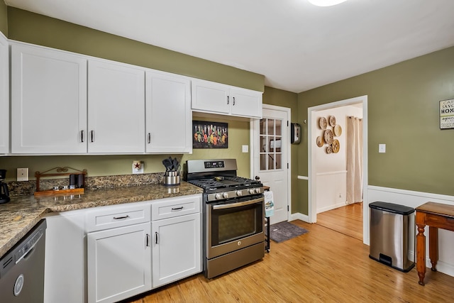 kitchen featuring dishwasher, white cabinets, and stainless steel gas range