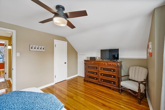 bedroom featuring vaulted ceiling, ceiling fan, and wood-type flooring