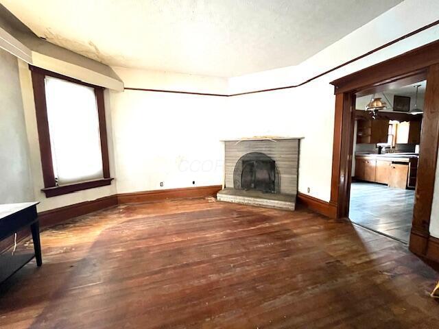 unfurnished living room featuring dark hardwood / wood-style flooring