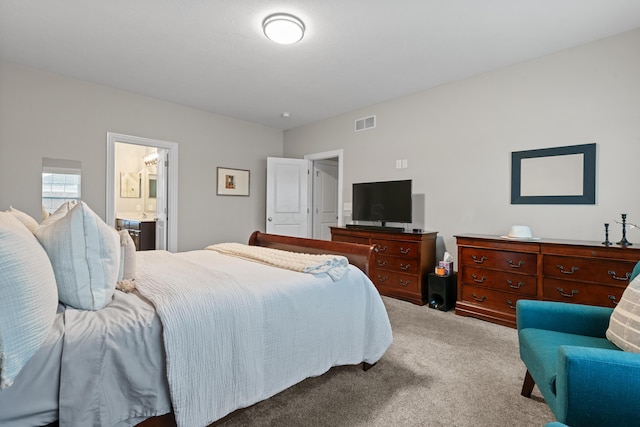 carpeted bedroom with ensuite bath