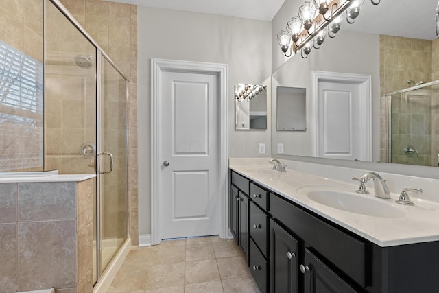 bathroom with vanity, tile patterned flooring, and a shower with door