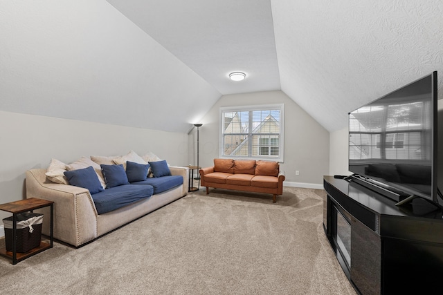 living room with lofted ceiling, light colored carpet, and a textured ceiling