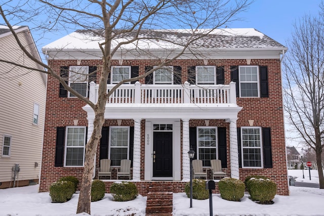 colonial-style house featuring a balcony