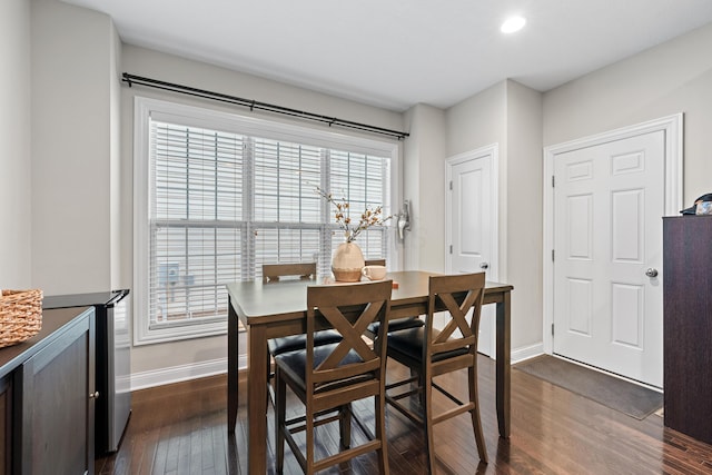 dining area with dark hardwood / wood-style floors