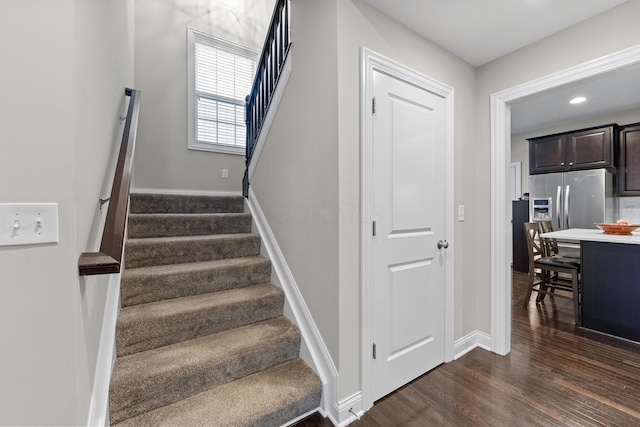 stairs featuring wood-type flooring