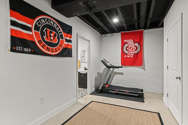 exercise area with sink and brick wall