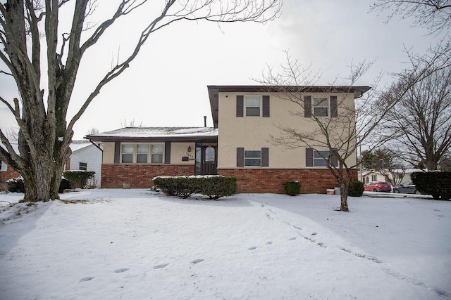 traditional-style home with brick siding and stucco siding