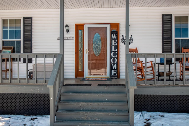 view of snow covered property entrance