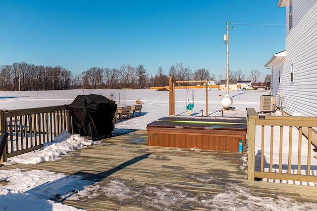 snow covered deck featuring cooling unit, area for grilling, and a hot tub