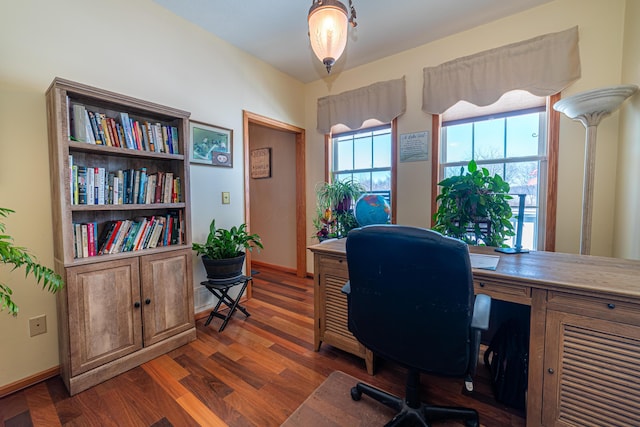 home office with dark hardwood / wood-style floors