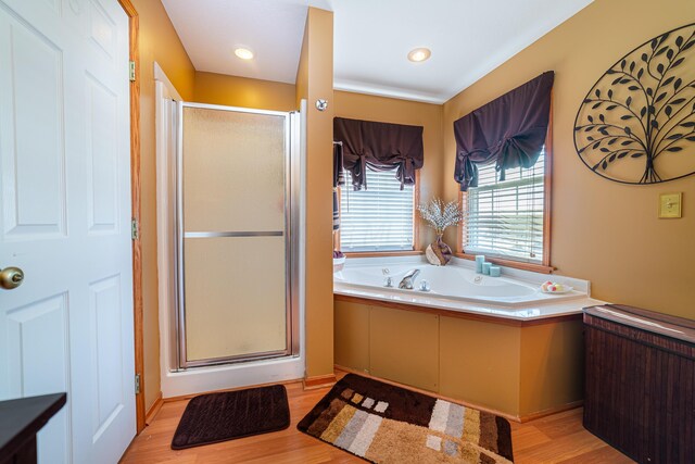 bathroom featuring hardwood / wood-style flooring and independent shower and bath