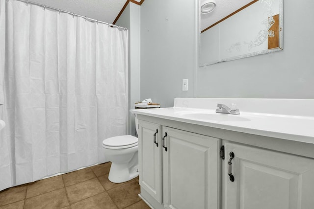 bathroom with toilet, vanity, tile patterned flooring, and a textured ceiling