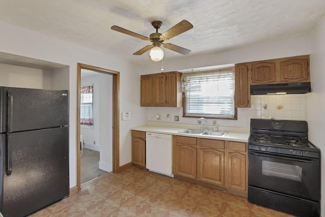 10 Main St, Orient, OH 43146 - kitchen featuring black appliances, under cabinet range hood, a sink, and brown cabinetry