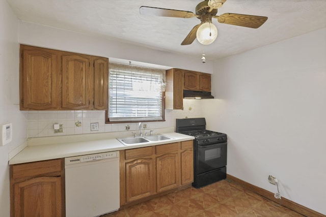 10 Main St, Orient, OH 43146 - kitchen with white dishwasher, black gas range, a sink, under cabinet range hood, and decorative backsplash