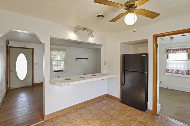 10 Main St, Orient, OH 43146 - kitchen with freestanding refrigerator, tile countertops, healthy amount of natural light, and baseboards