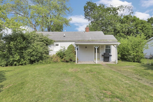 10 Main St, Orient, OH 43146 - rear view of house with a patio, a lawn, a chimney, and roof with shingles