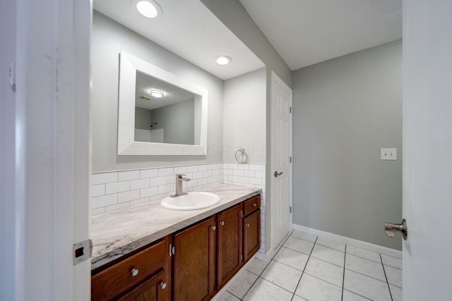 bathroom with decorative backsplash, tile patterned floors, and vanity