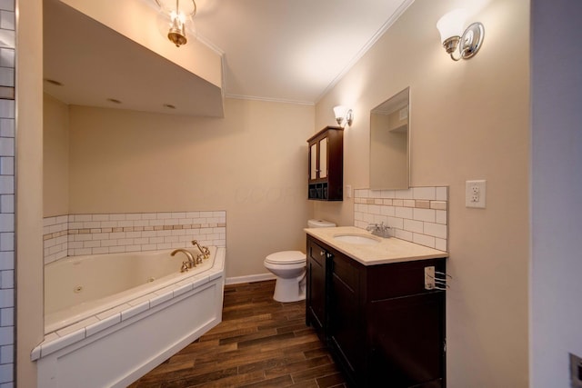 bathroom with toilet, vanity, hardwood / wood-style floors, ornamental molding, and a bathtub