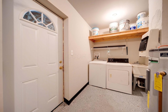 washroom with electric water heater, sink, and washer and dryer