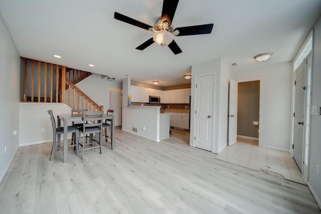 dining room featuring ceiling fan and light hardwood / wood-style floors