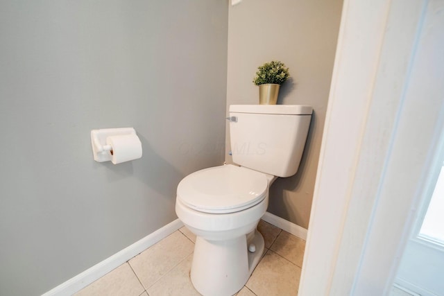 bathroom with toilet and tile patterned flooring