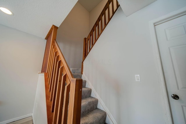 stairs featuring hardwood / wood-style flooring