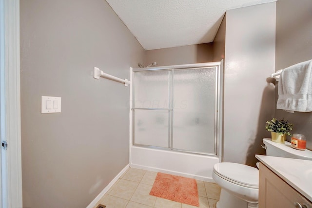 full bathroom featuring a textured ceiling, tile patterned floors, vanity, bath / shower combo with glass door, and toilet