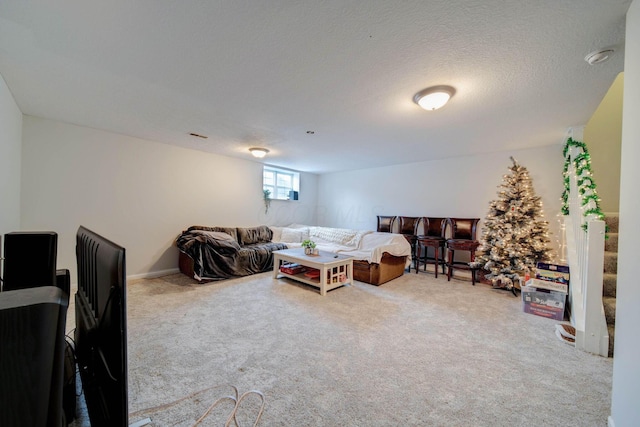 carpeted living room featuring a textured ceiling