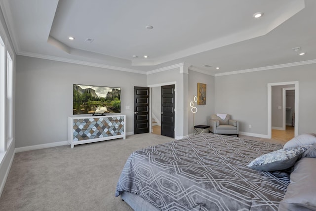 carpeted bedroom with a raised ceiling and crown molding