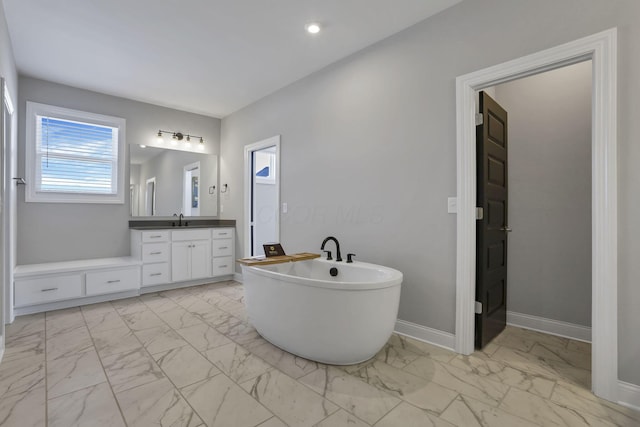 bathroom with vanity and a bath