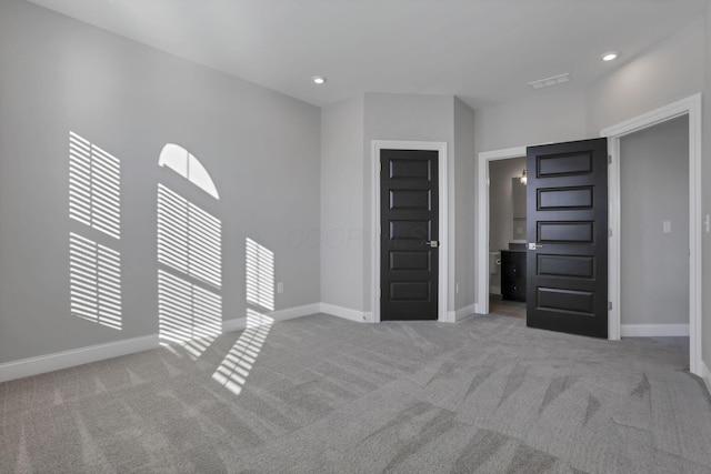 unfurnished bedroom with light colored carpet