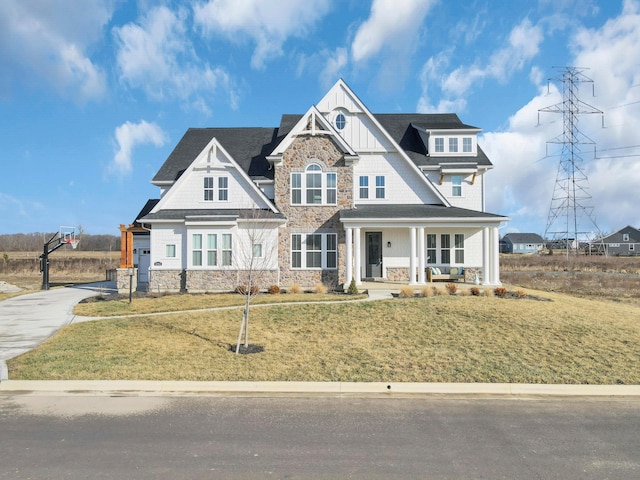 craftsman inspired home featuring a front lawn and covered porch