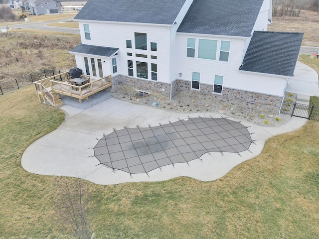 back of property with a wooden deck, a yard, and a patio area