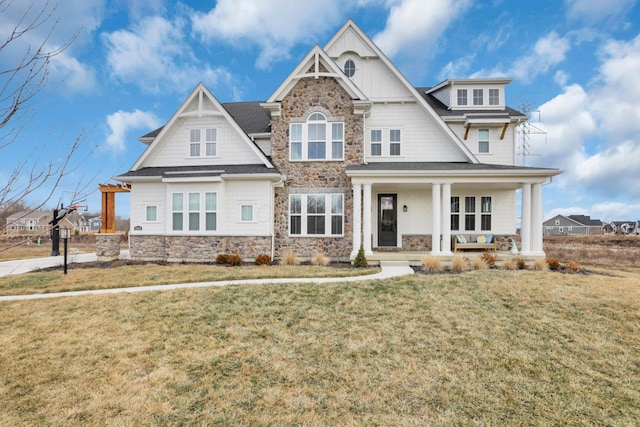 craftsman-style house featuring a porch and a front lawn