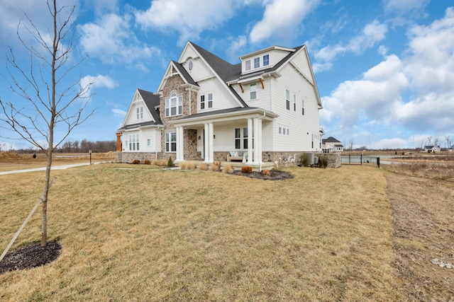 view of front facade with covered porch and a front lawn