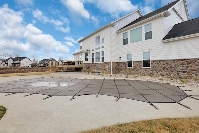 view of swimming pool featuring a deck and a patio area