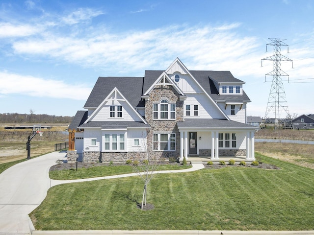 6764 Woodedge Ln, Hilliard, OH 43026 - craftsman-style house with board and batten siding, stone siding, a front lawn, and covered porch