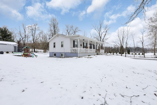 exterior space featuring a playground and covered porch