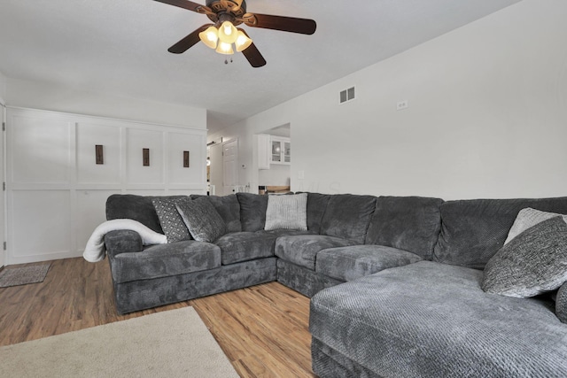 living room featuring hardwood / wood-style flooring and ceiling fan