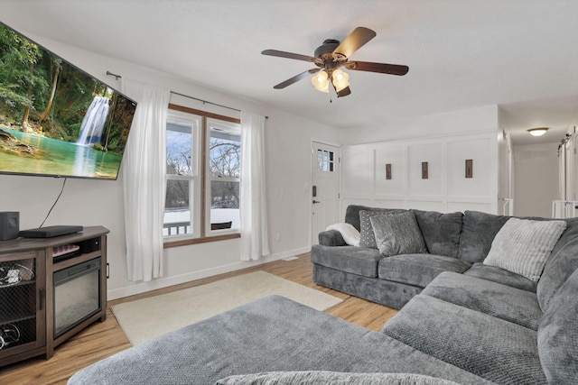 living room featuring ceiling fan and light wood-type flooring