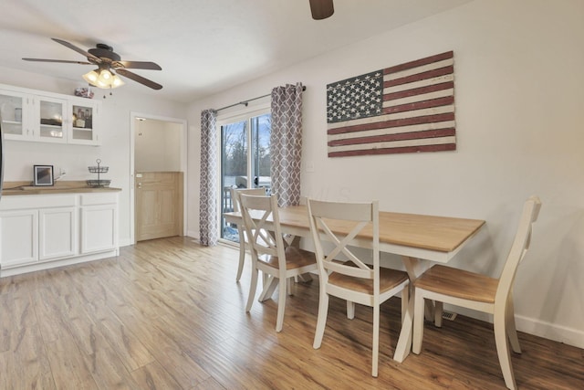 dining space featuring ceiling fan and light hardwood / wood-style floors