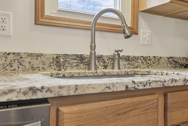 room details featuring stainless steel dishwasher and sink