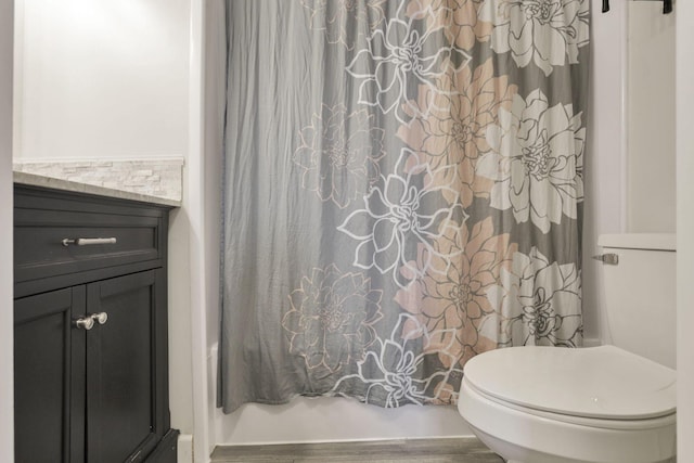 full bathroom featuring vanity, shower / bath combination with curtain, and toilet