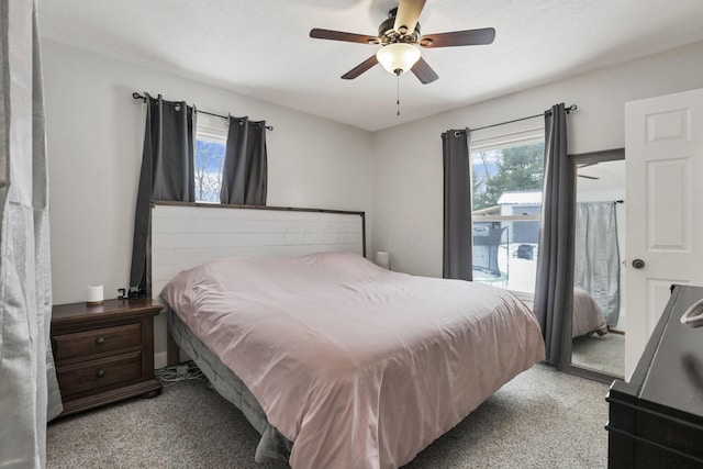 carpeted bedroom with ceiling fan and access to outside